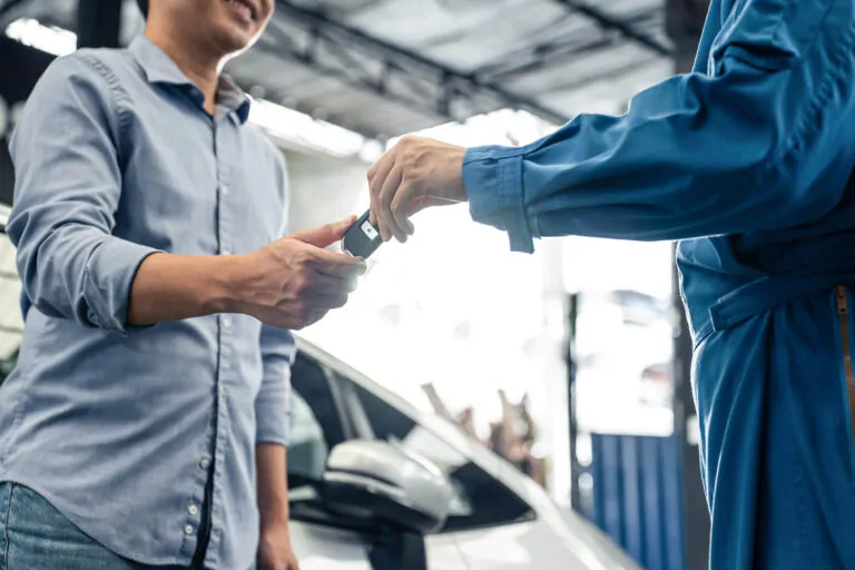 asian-automotive-mechanic-repairman-handing-car-re-2023-08-11-17-49-57-utc